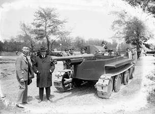 Photograph:John Walter Christie, left, and Secretary of the Navy Edwin Denby view a gun carriage design in 1924.